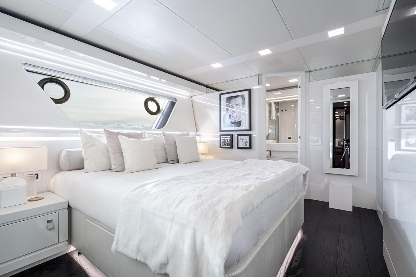 a bedroom with a bed and a mirror aboard YVONNE Yacht for Sale