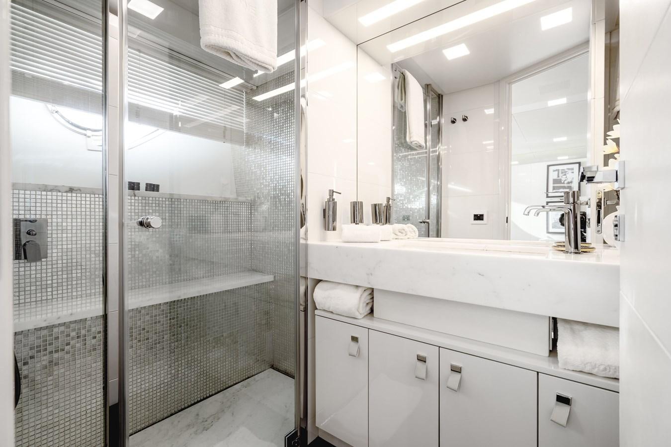a bathroom with a glass shower aboard YVONNE Yacht for Sale