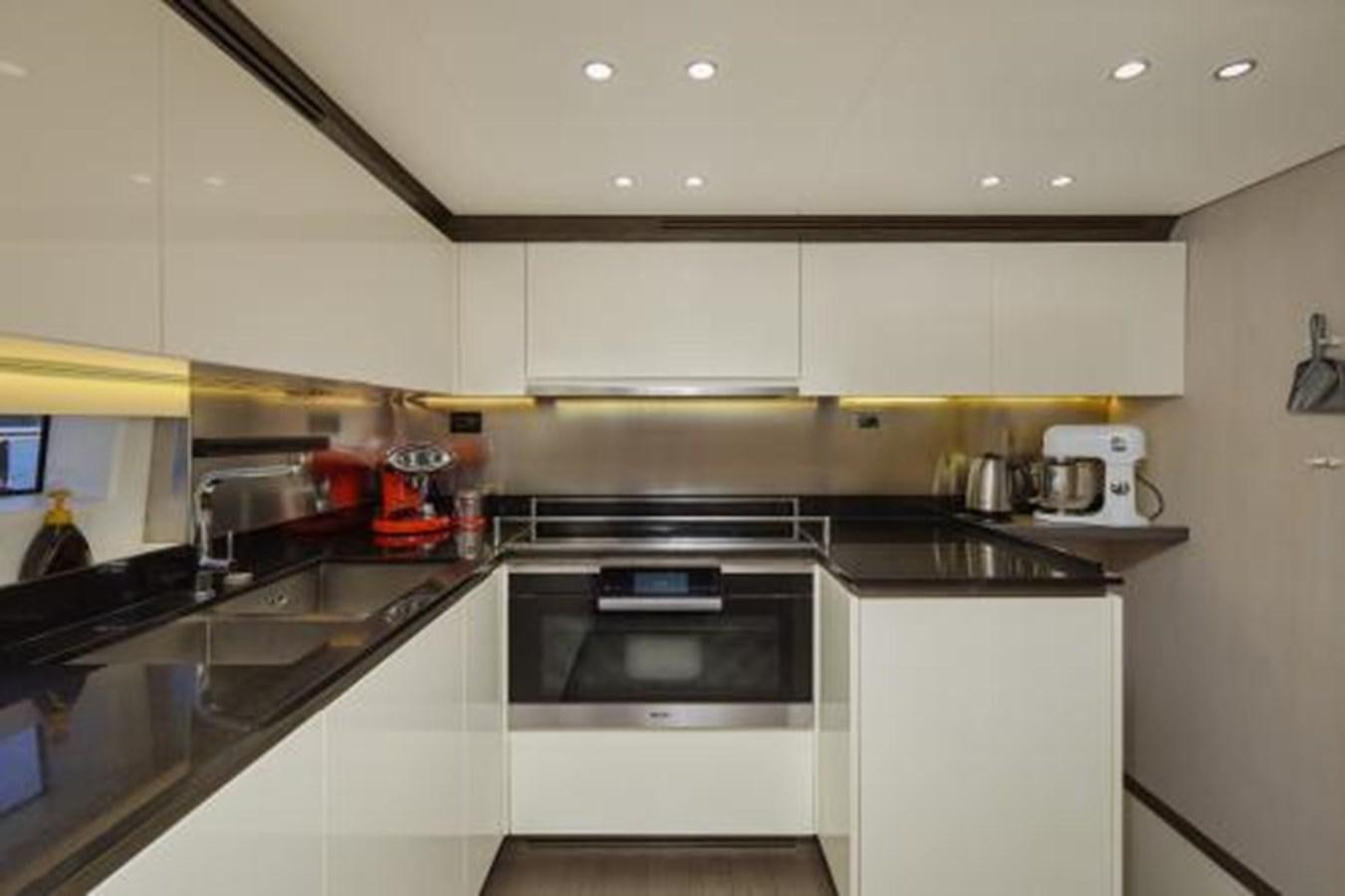 a kitchen with white cabinets aboard SILVIA Yacht for Sale
