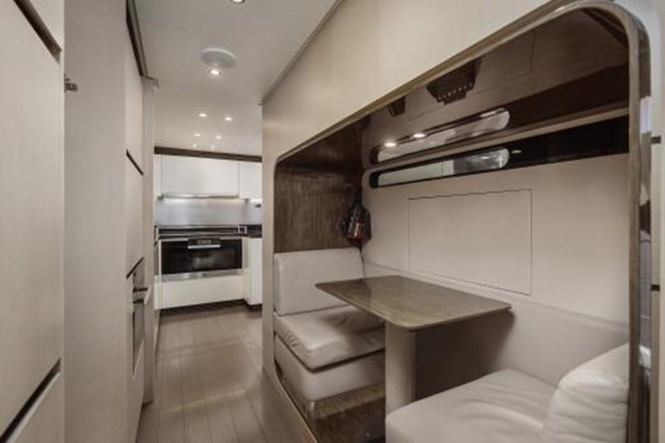 a kitchen with a table and a couch aboard SILVIA Yacht for Sale