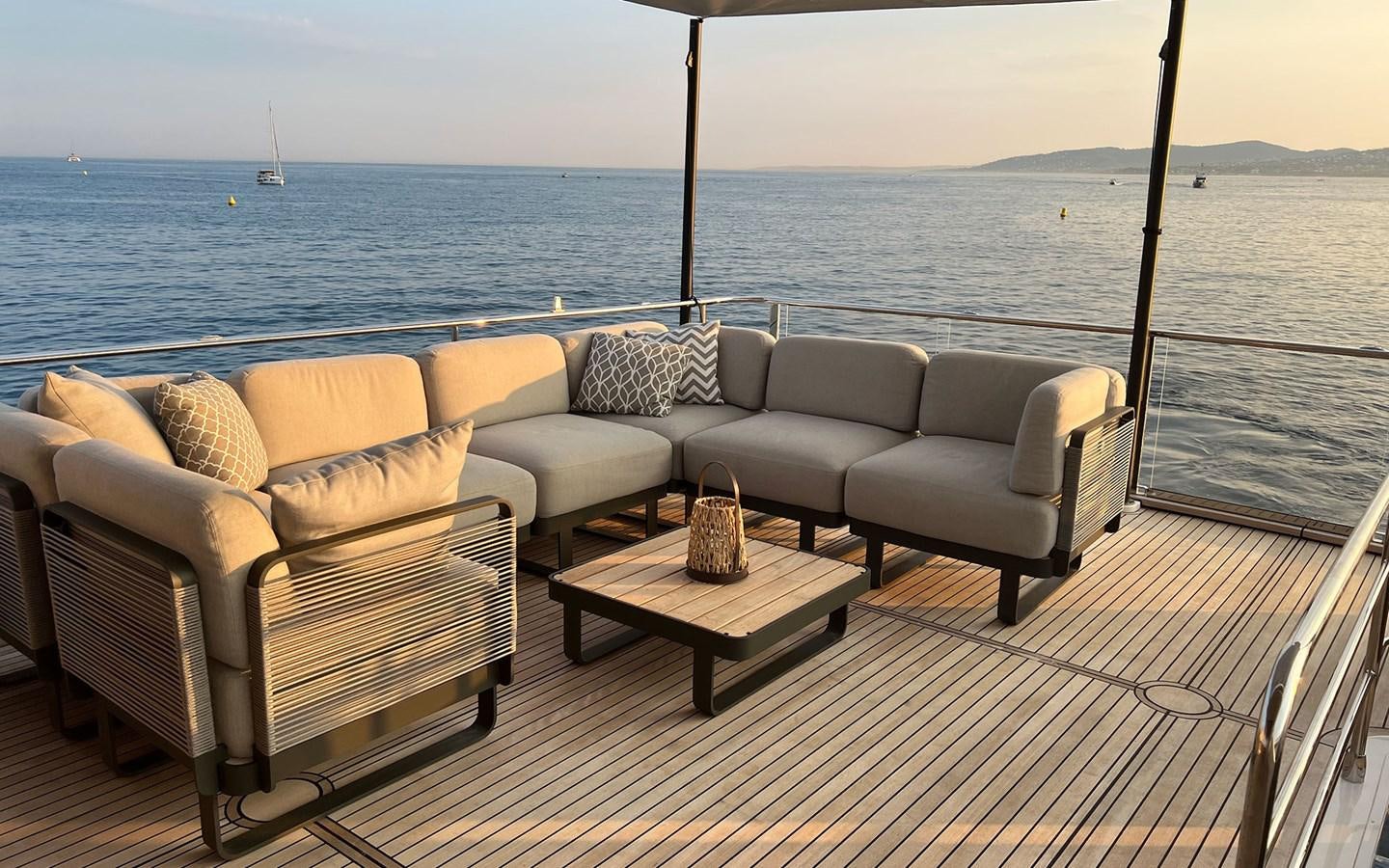 a couple of couches on a deck overlooking a body of water aboard A4A Yacht for Sale