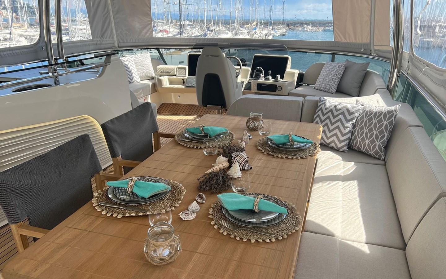 a living room with a couch and a table aboard A4A Yacht for Sale