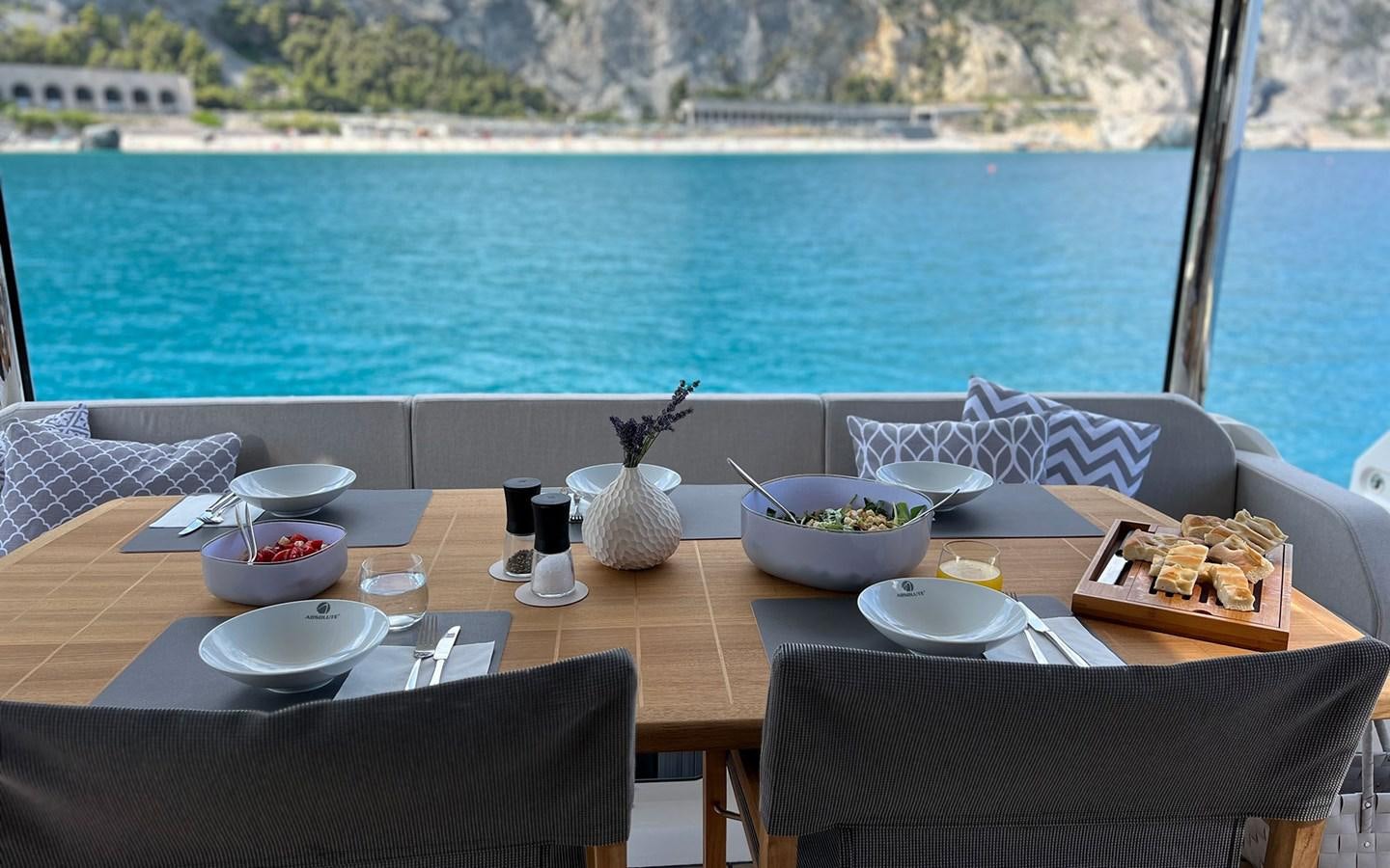 a table with food on it by a body of water aboard A4A Yacht for Sale