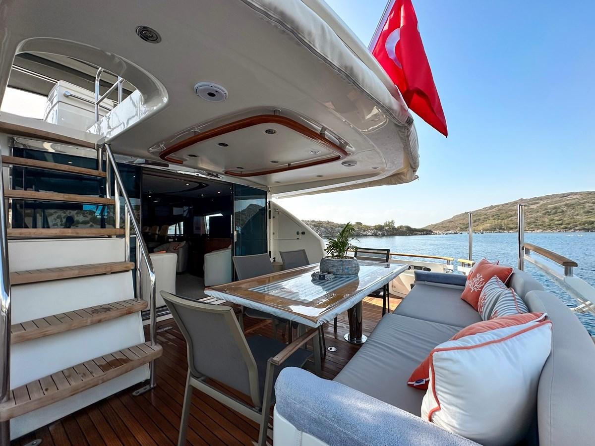 a boat with a table and chairs on a deck aboard FAIRLINE SQUADRON 74 Yacht for Sale