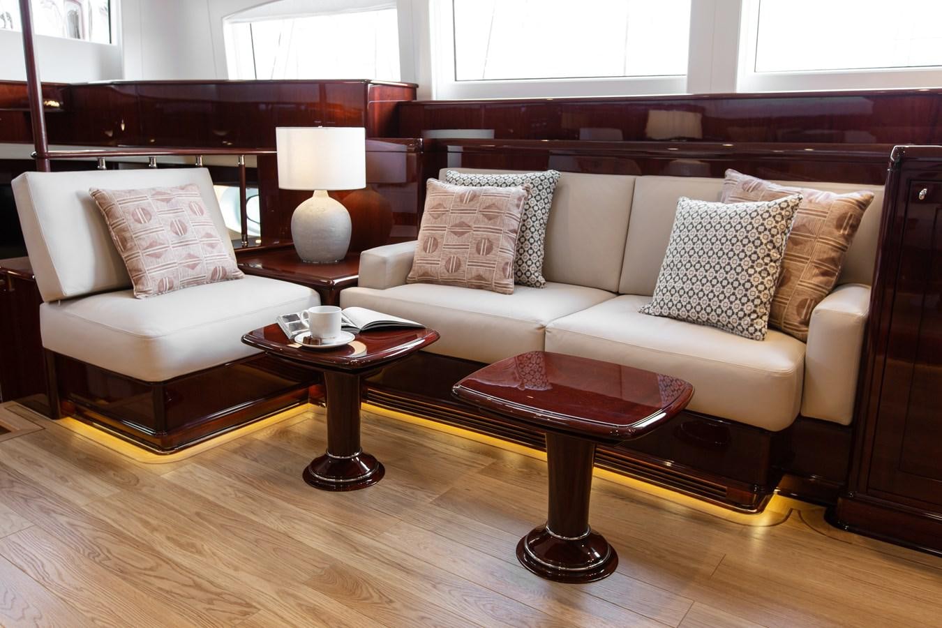 a living room with a couch and coffee table aboard GRACE III Yacht for Sale