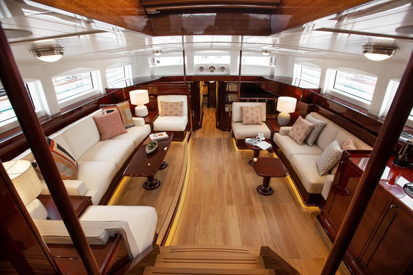 a room with a couch and a piano aboard GRACE III Yacht for Sale