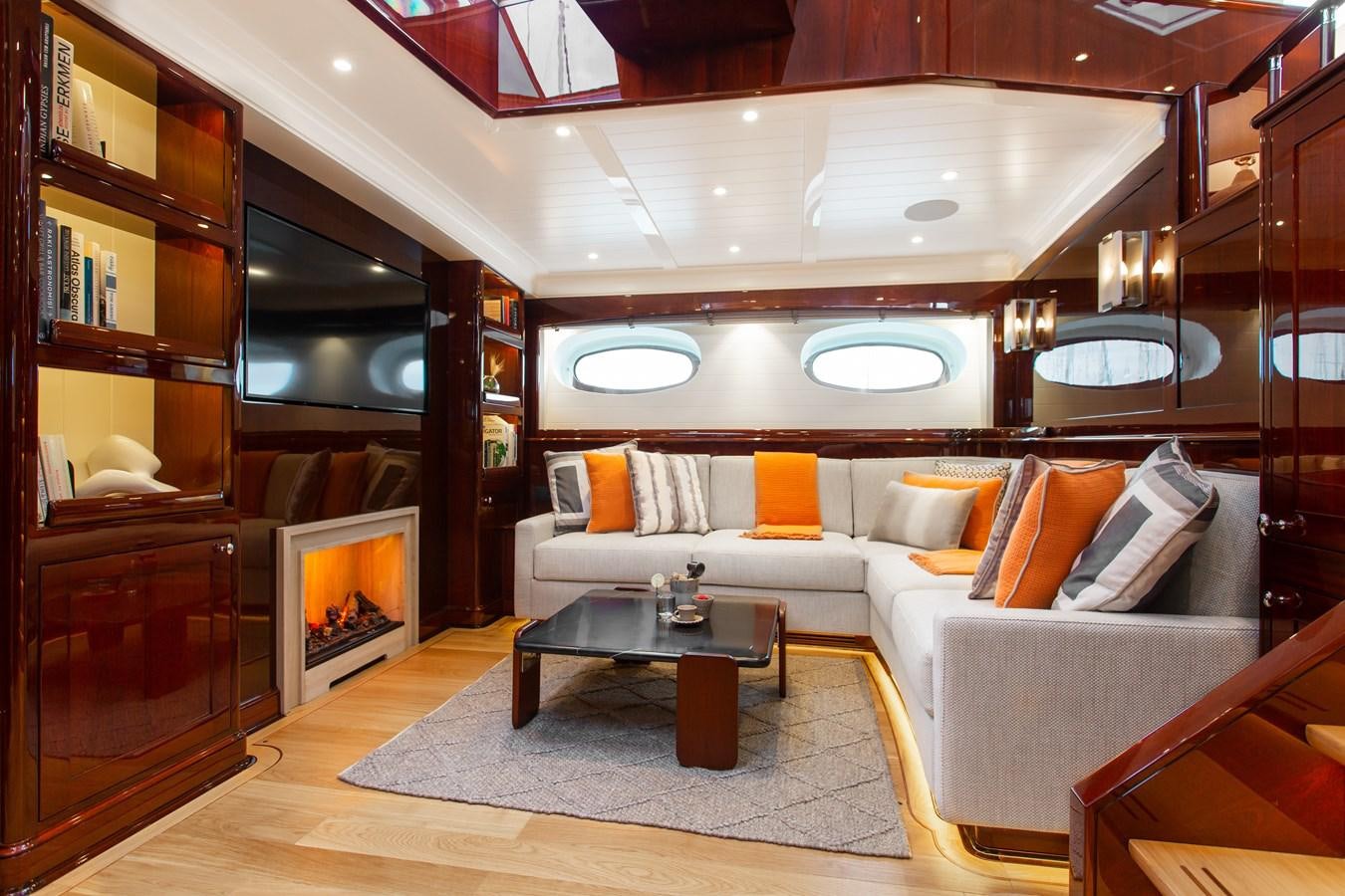 a living room with a large mirror aboard GRACE III Yacht for Sale