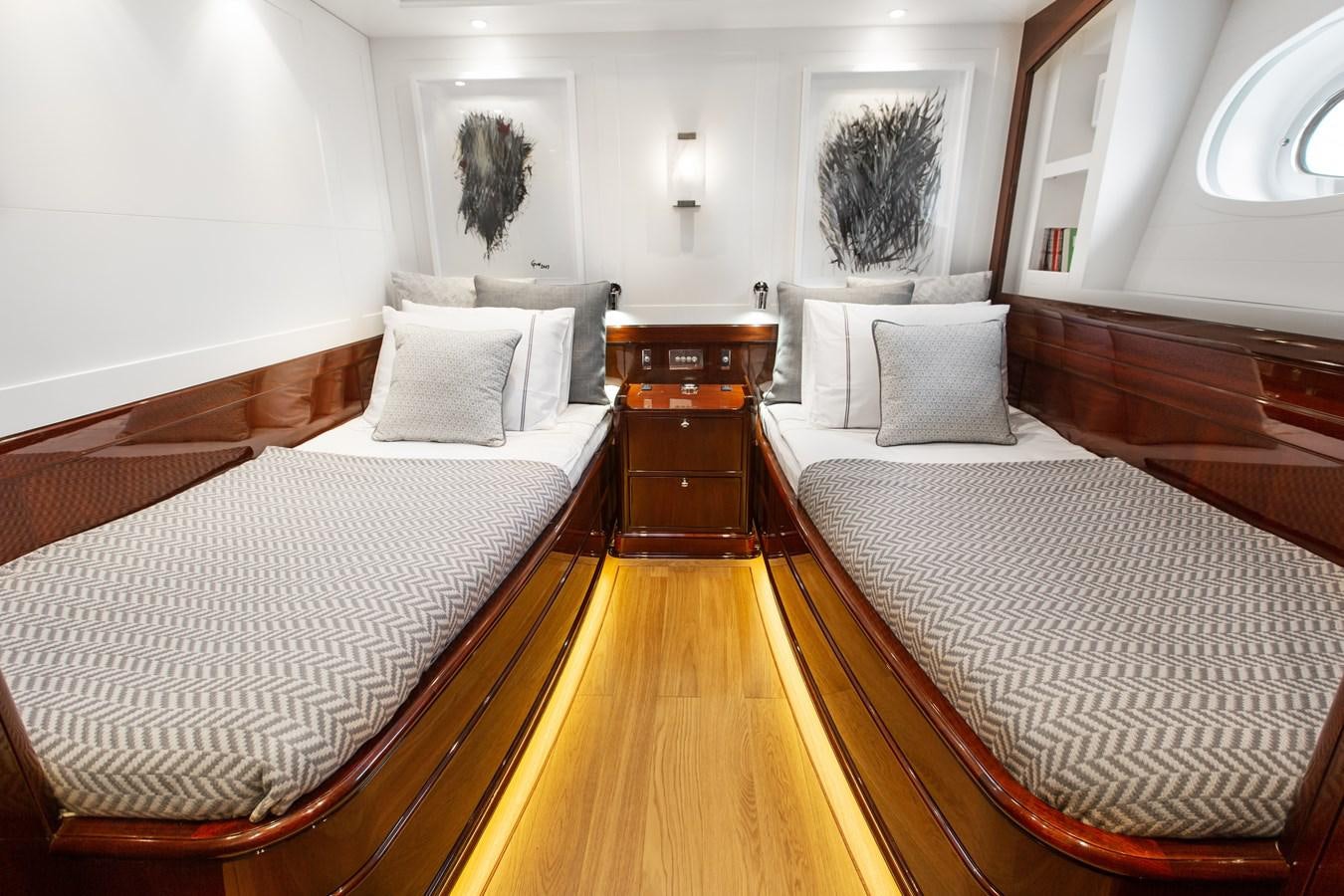 a room with a couple of beds aboard GRACE III Yacht for Sale