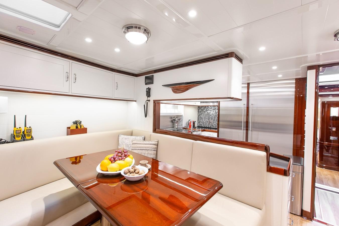 a kitchen with white cabinets aboard GRACE III Yacht for Sale