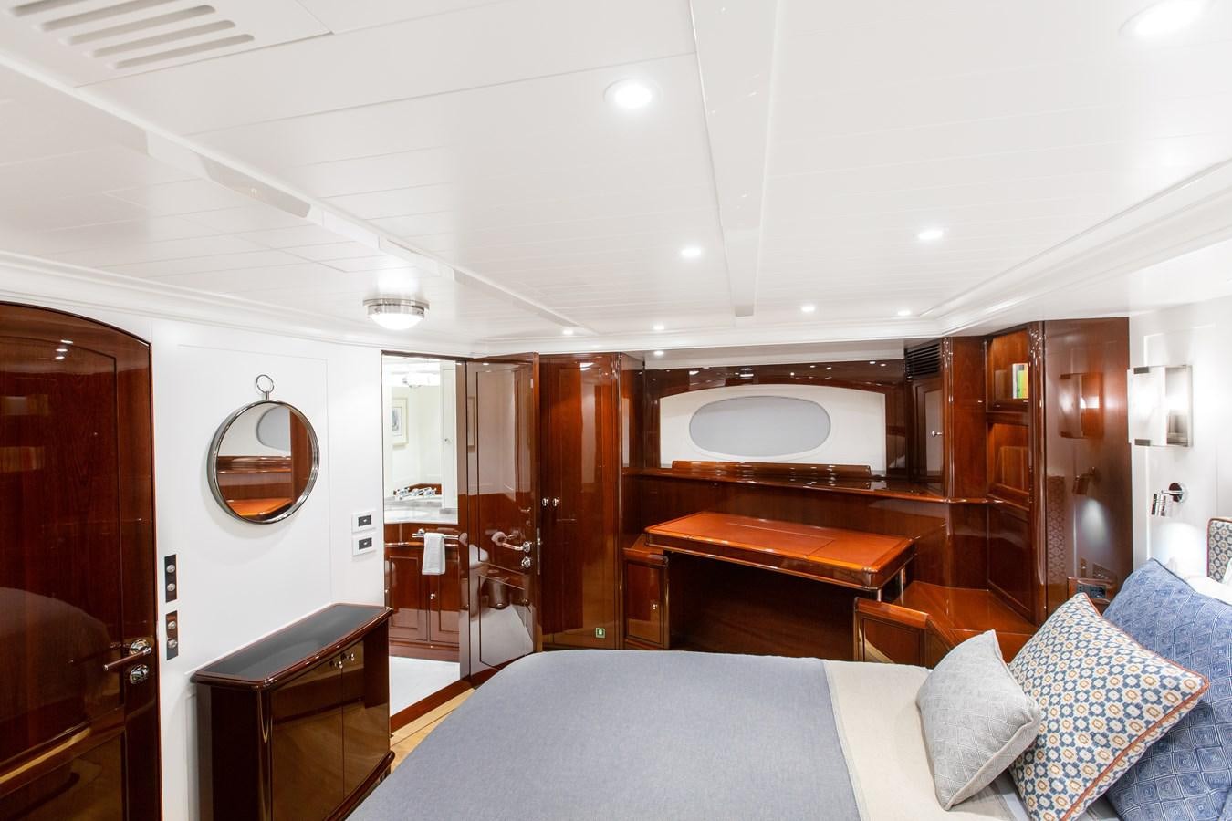 a bedroom with a bed and a desk aboard GRACE III Yacht for Sale