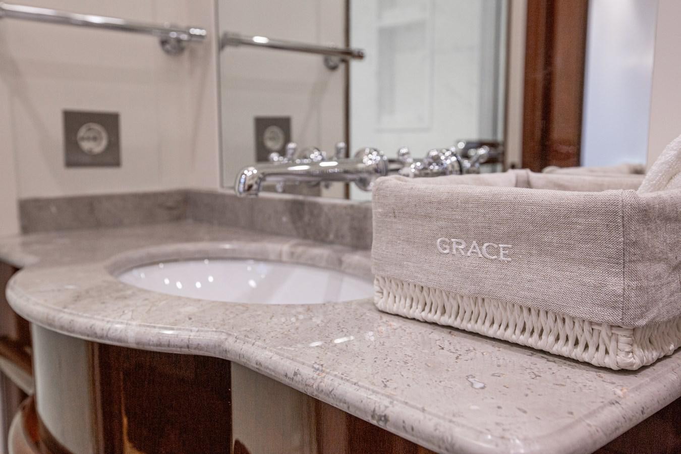 a bathroom with a sink and towels aboard GRACE III Yacht for Sale