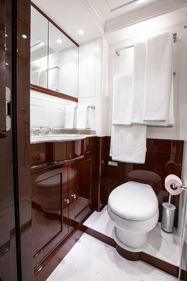 a bathroom with a toilet and a sink aboard GRACE III Yacht for Sale
