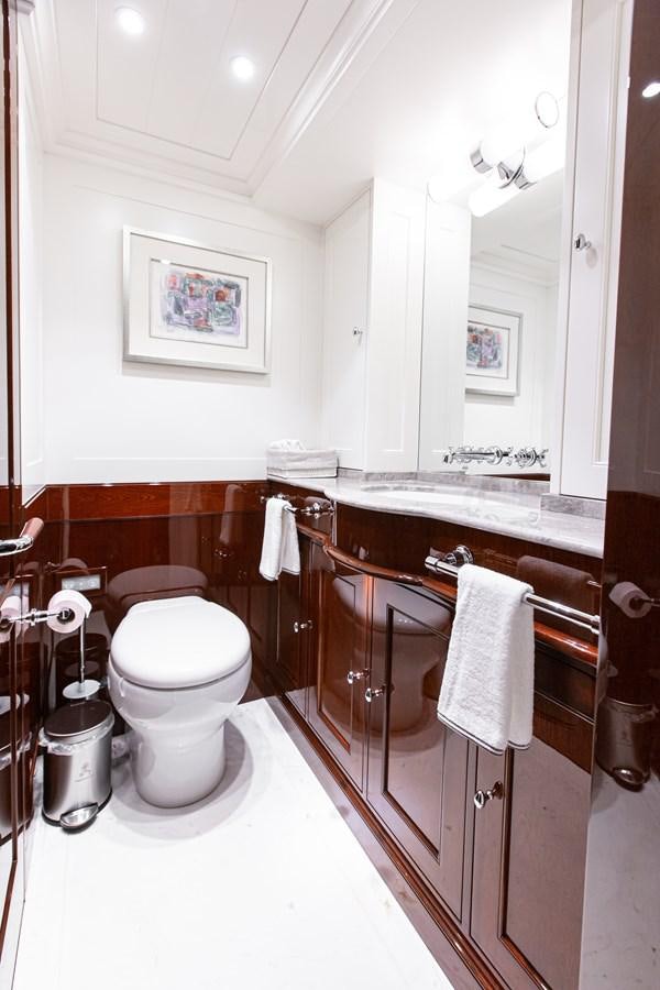a bathroom with a toilet and a sink aboard GRACE III Yacht for Sale