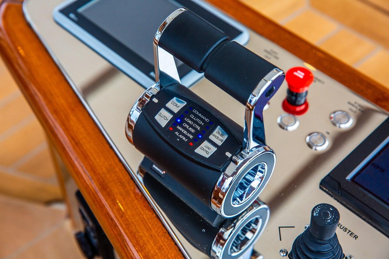 a black and red telephone on a wooden surface aboard GRACE III Yacht for Sale