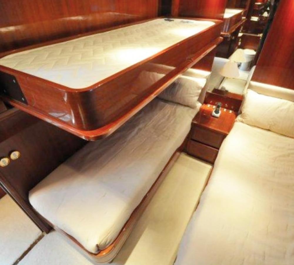 a wooden bed frame aboard NAISCA IV Yacht for Sale