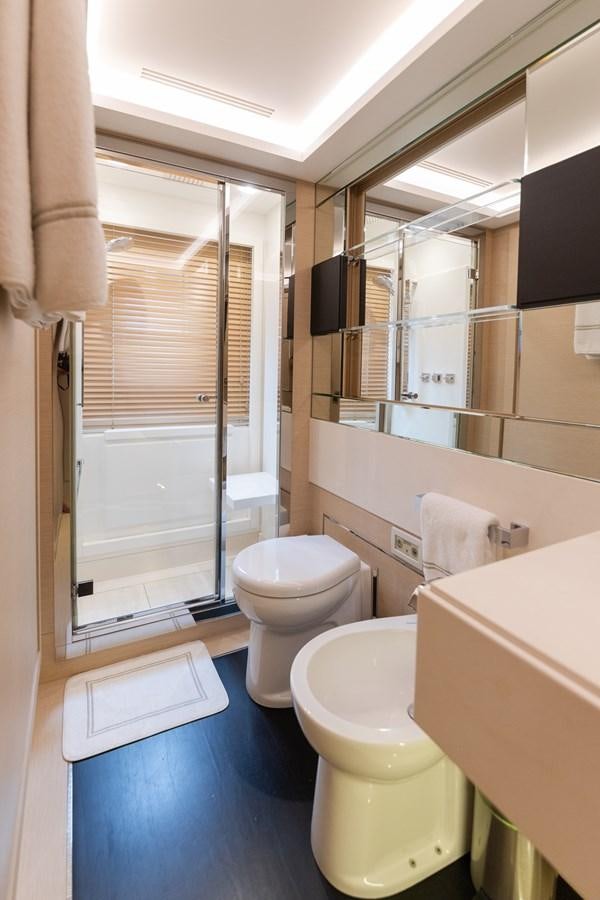 a bathroom with a toilet and a bathtub aboard LIBERTY CALL Yacht for Sale