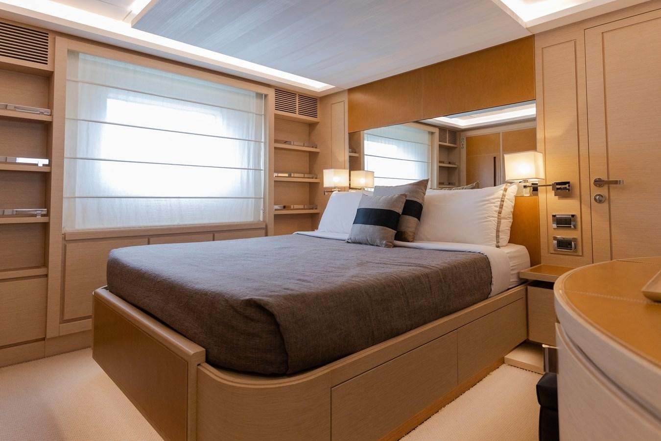 a bed with a white pillow aboard LIBERTY CALL Yacht for Sale