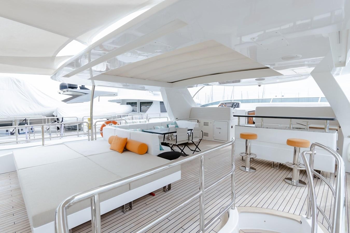 a white yacht with stools aboard LIBERTY CALL Yacht for Sale