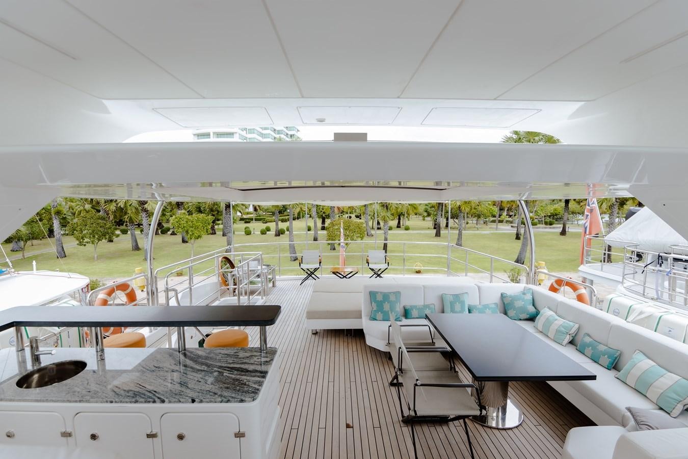 a large white building with tables and chairs aboard LIBERTY CALL Yacht for Sale