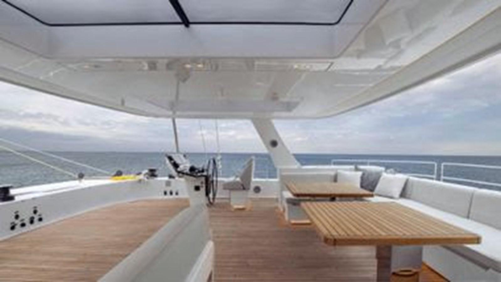 a room with a table and chairs aboard TRUE NORTH Yacht for Sale