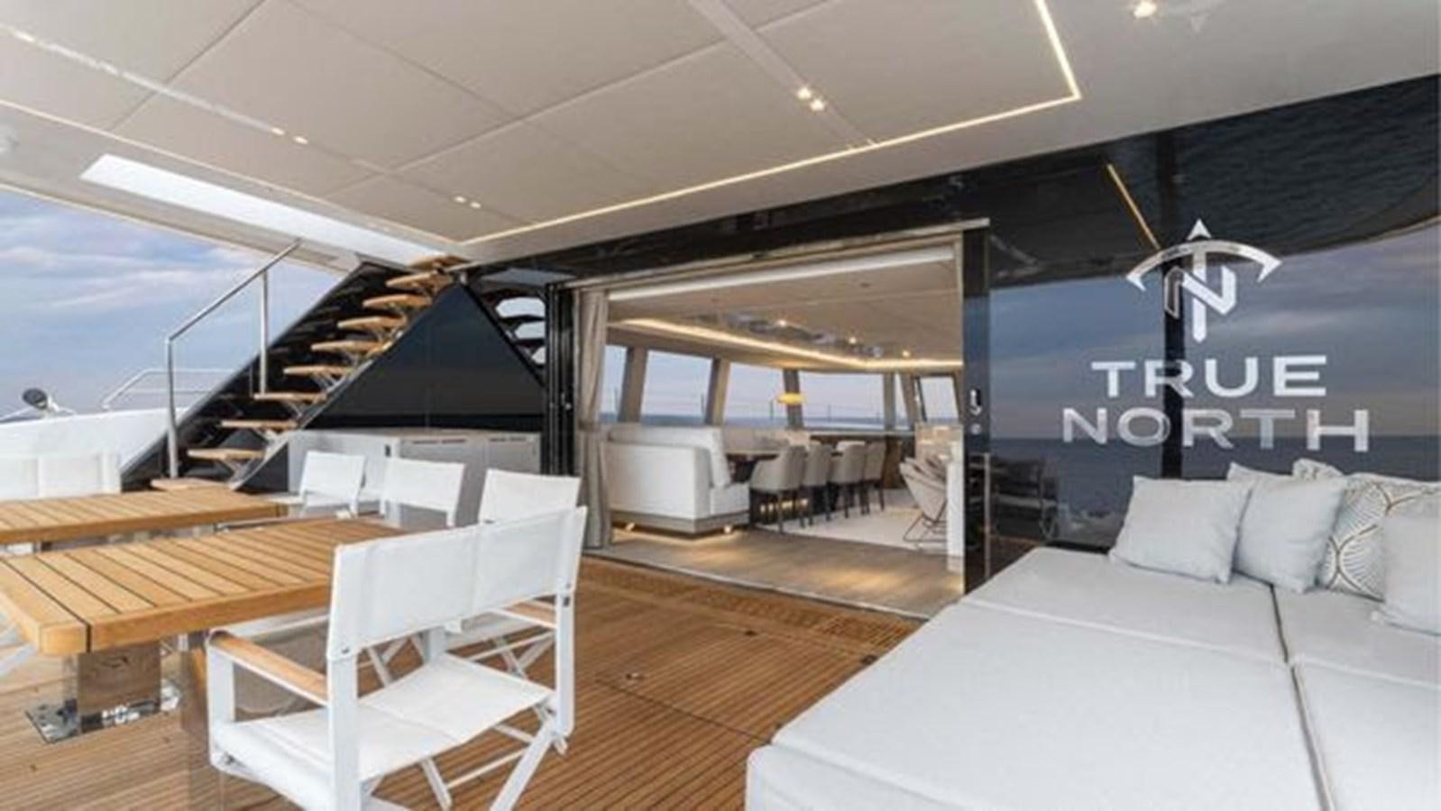 a room with a bed and a desk aboard TRUE NORTH Yacht for Sale
