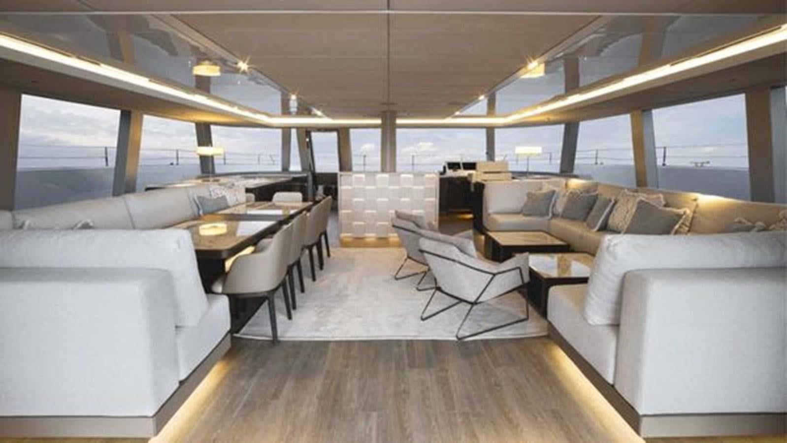 a room with couches and a table aboard TRUE NORTH Yacht for Sale