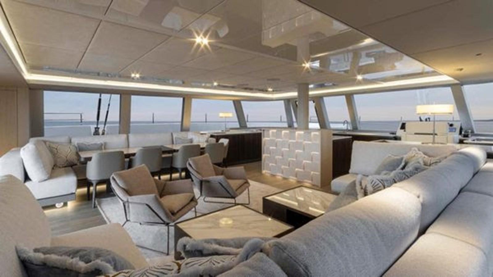 a large room with a couch and a table aboard TRUE NORTH Yacht for Sale