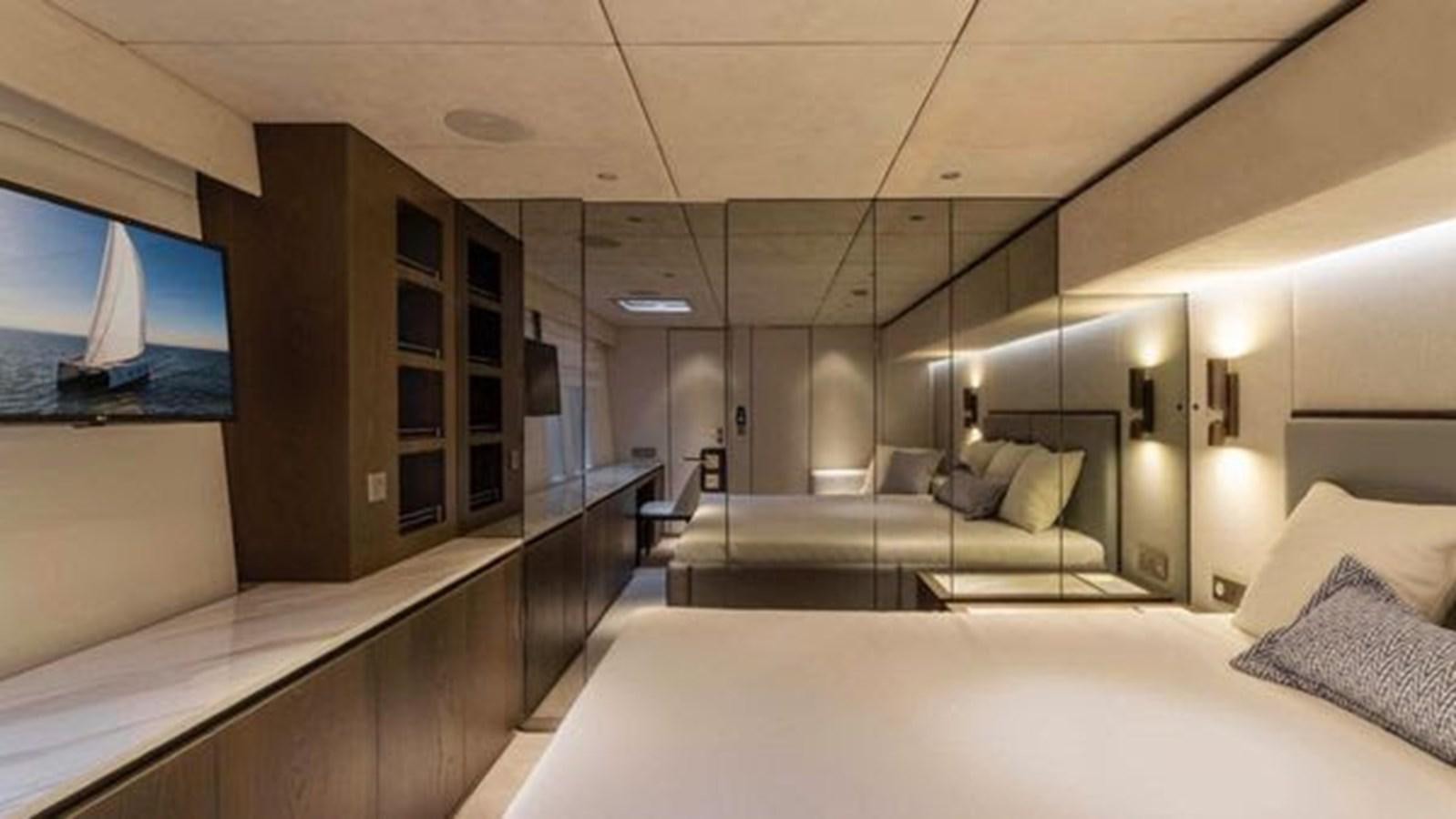 a room with a bed and a large mirror aboard TRUE NORTH Yacht for Sale