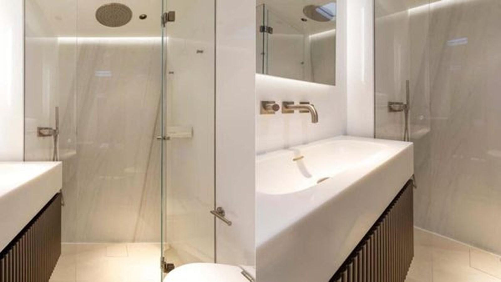 a bathroom with a glass shower aboard TRUE NORTH Yacht for Sale