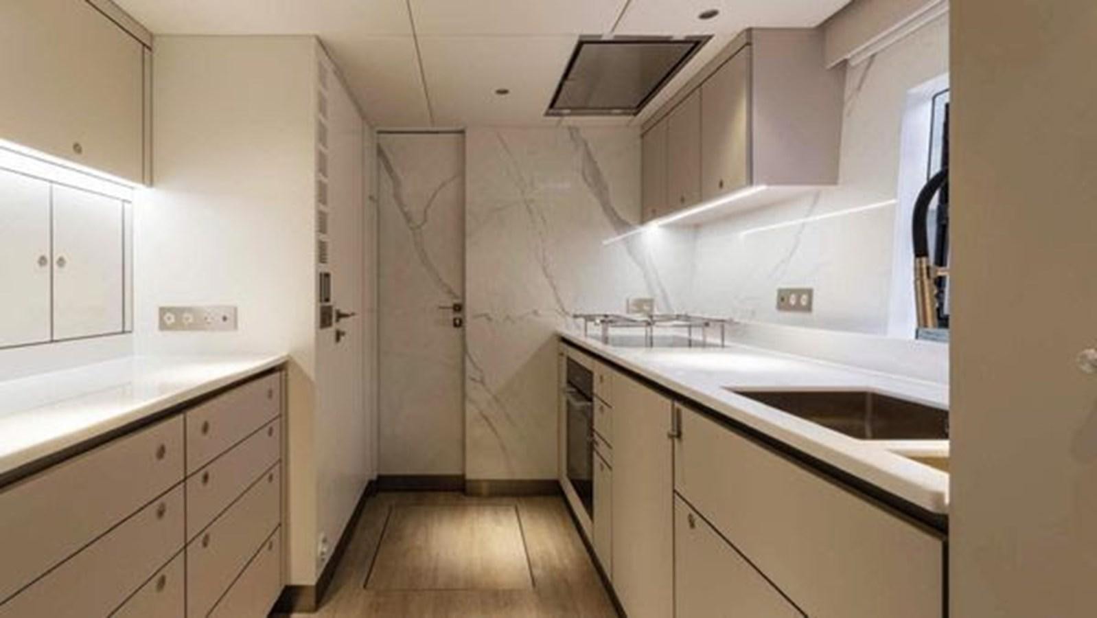 a kitchen with white cabinets aboard TRUE NORTH Yacht for Sale