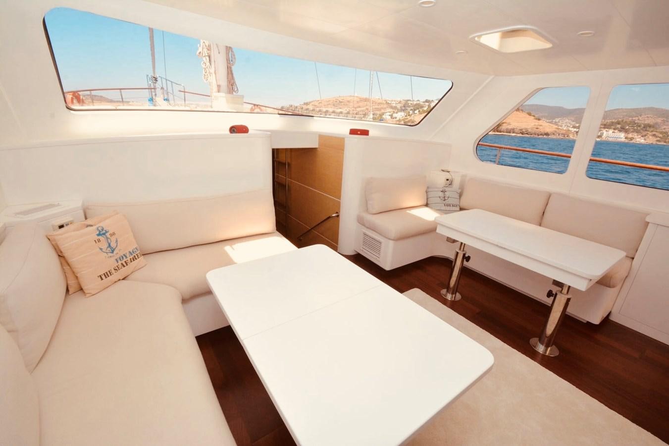 a room with a couch and a table aboard ELIFIM 11 Yacht for Sale