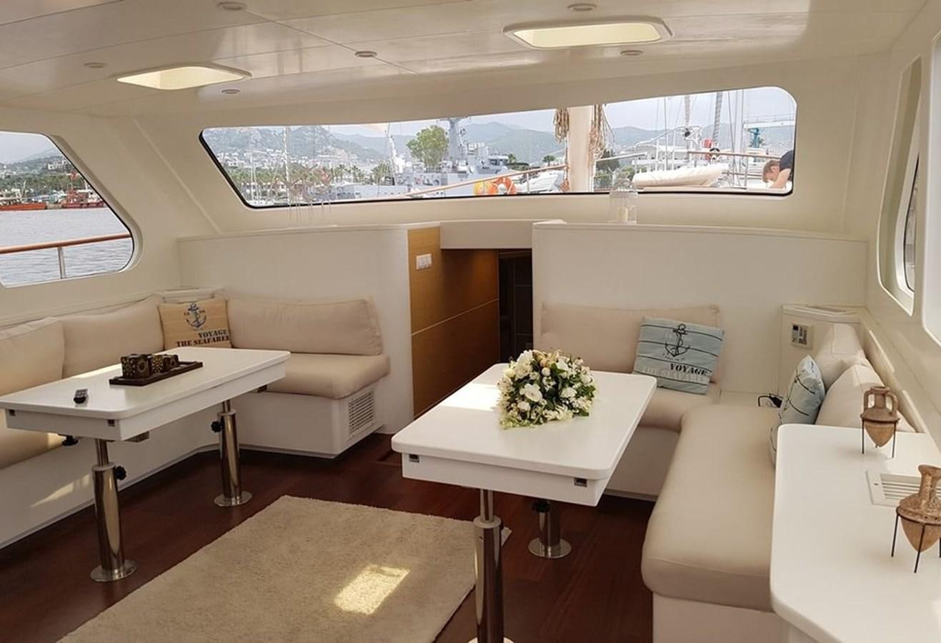 a room with a couch and a table aboard ELIFIM 11 Yacht for Sale