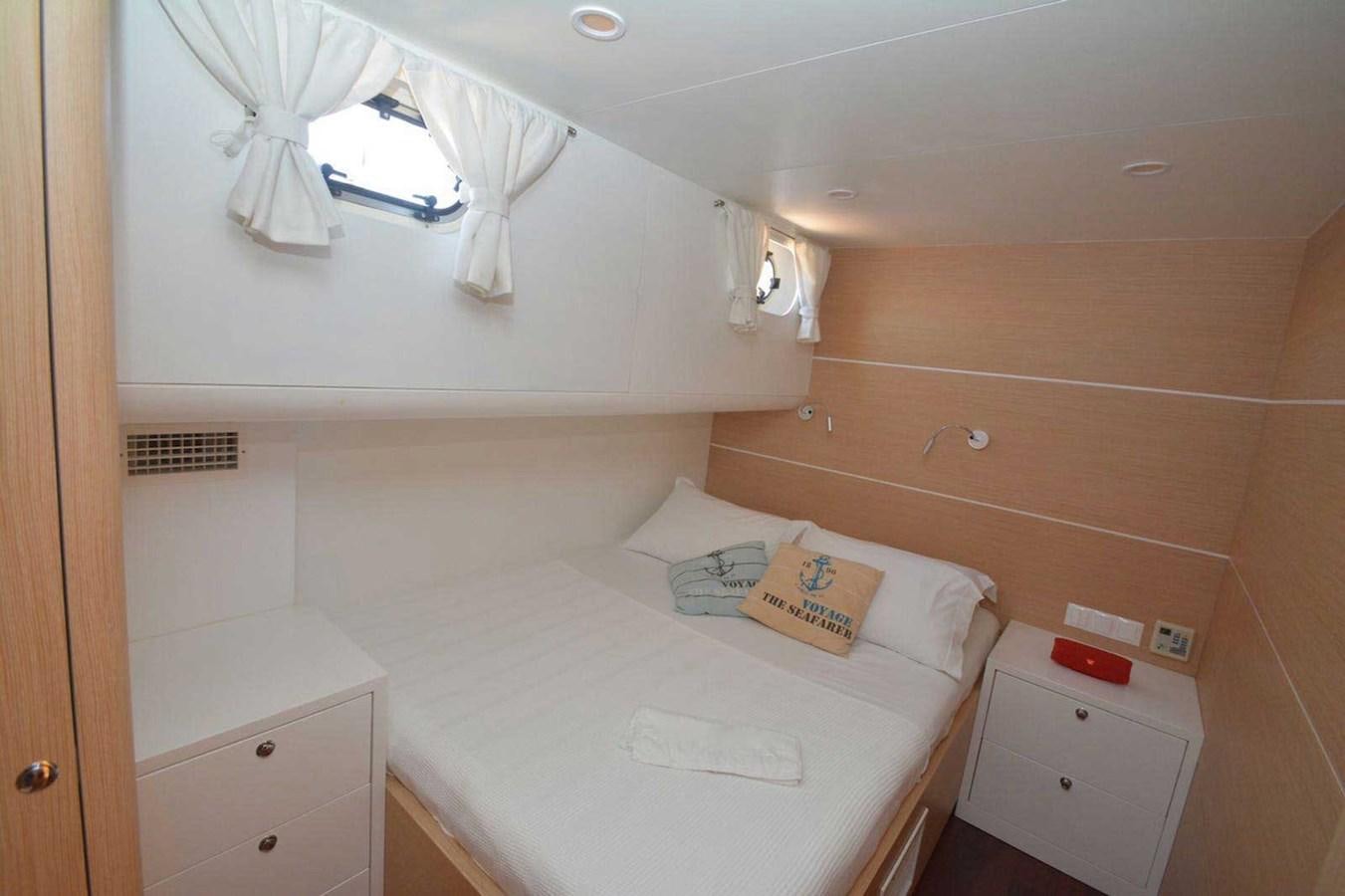 a bedroom with a bed and a fan aboard ELIFIM 11 Yacht for Sale