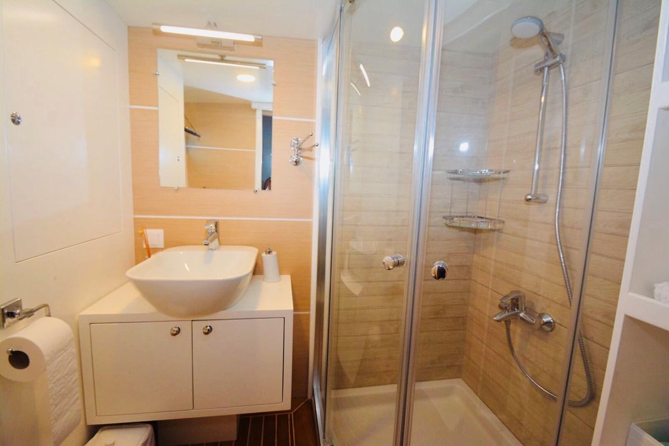 a bathroom with a glass shower aboard ELIFIM 11 Yacht for Sale