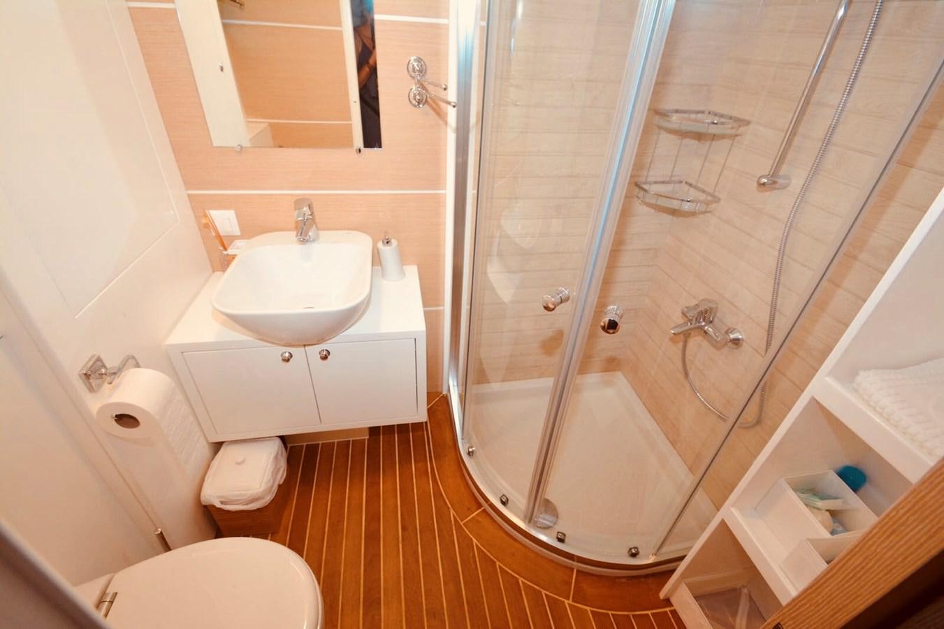 a bathroom with a glass shower aboard ELIFIM 11 Yacht for Sale