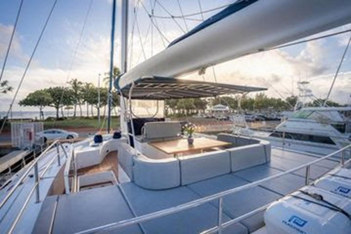 a large white tent with a table and chairs on it aboard 2012 SUNREEF C Yacht for Sale