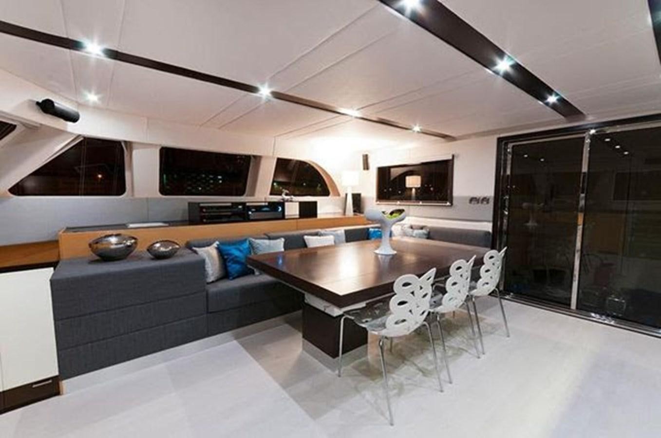 a living room with a couch and a table aboard 2012 SUNREEF C Yacht for Sale