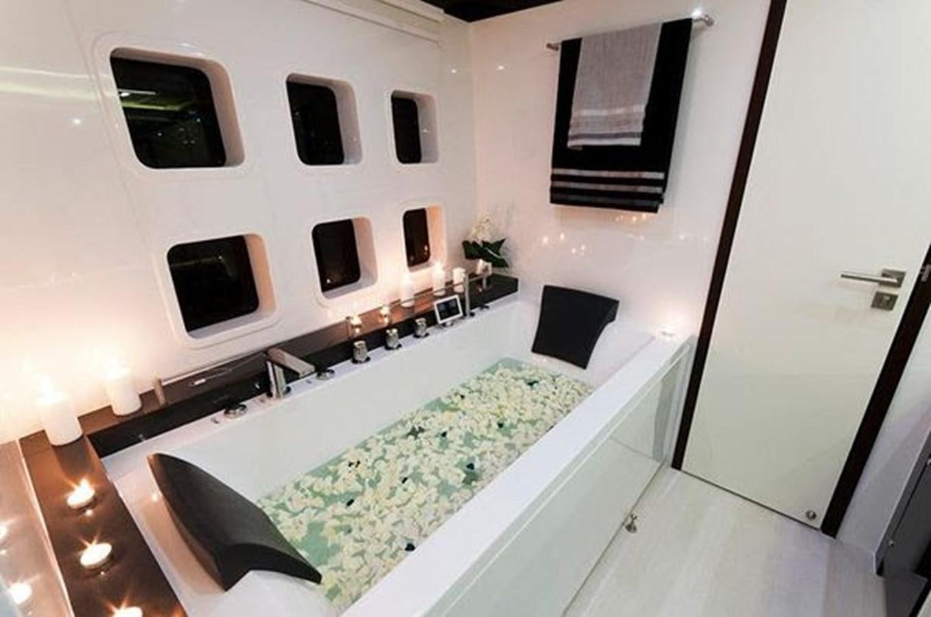 a room with a bed and a television aboard 2012 SUNREEF C Yacht for Sale