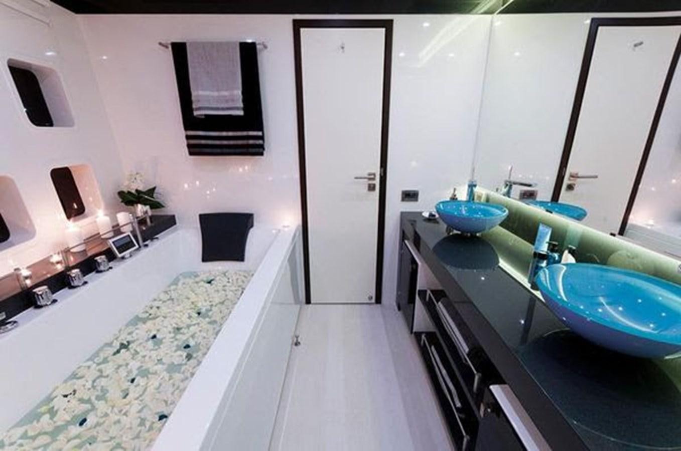 a bathroom with a tub sink and a mirror aboard 2012 SUNREEF C Yacht for Sale
