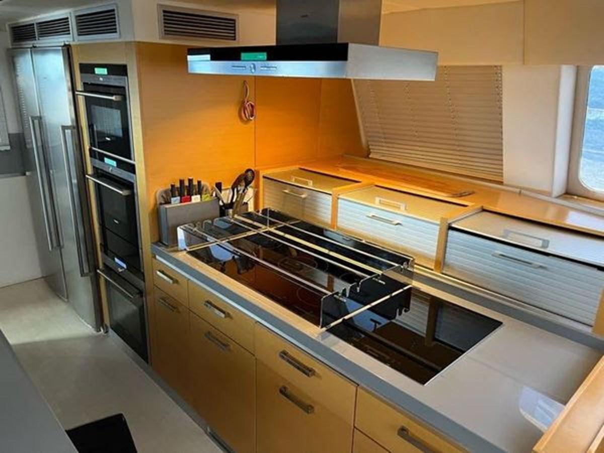 a kitchen with a stove and cabinets aboard 2012 SUNREEF C Yacht for Sale