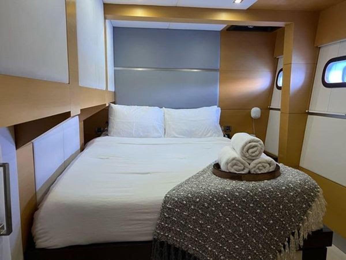 a bed with a white sheet and a white pillow on it aboard 2012 SUNREEF C Yacht for Sale