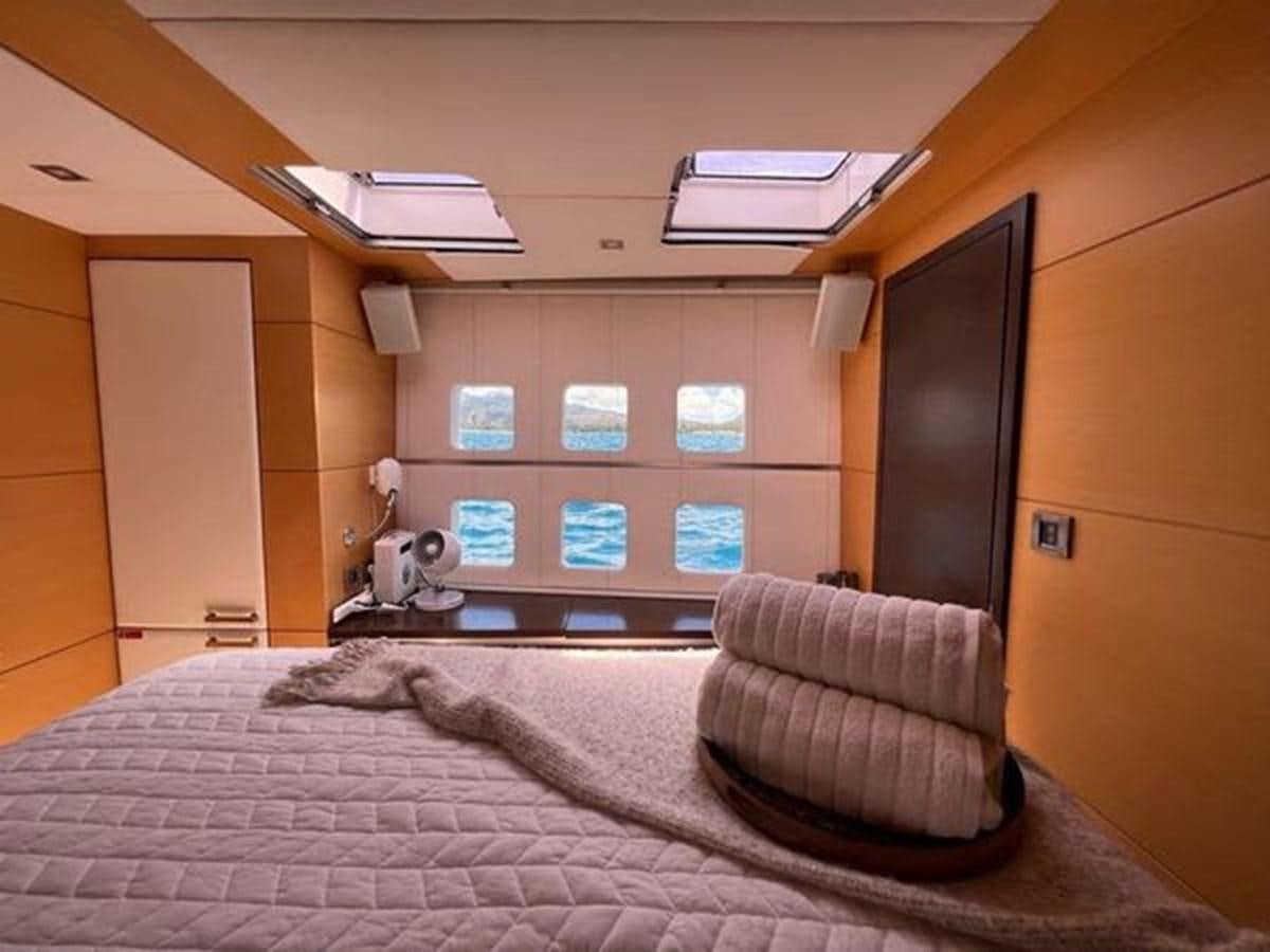 a bed with a laptop on it aboard 2012 SUNREEF C Yacht for Sale
