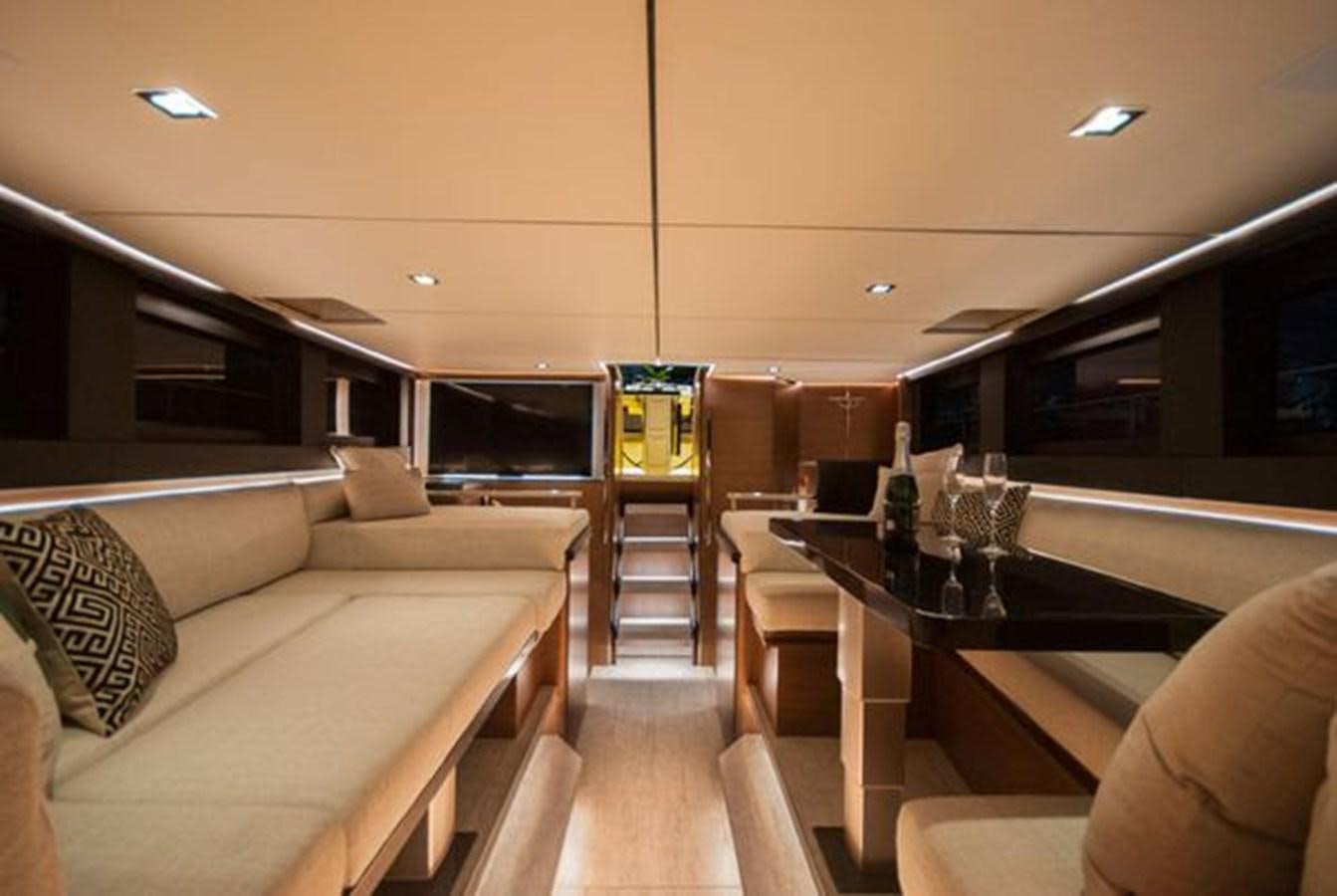a living room with a large glass table and a couch aboard 2024 MCP GLOBAL EXP 68 Yacht for Sale
