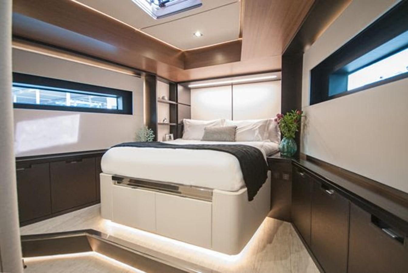 a room with a bed and a desk aboard 2024 MCP GLOBAL EXP 68 Yacht for Sale