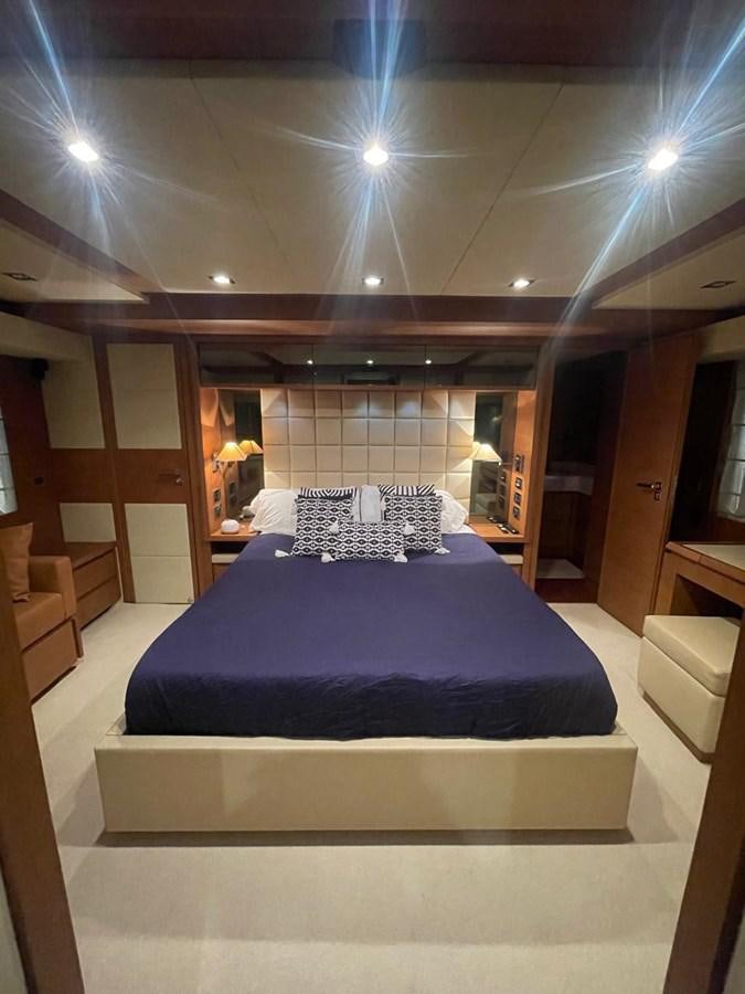 a large bed in a room aboard M&M Yacht for Sale