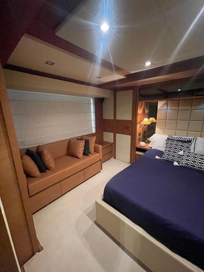 a room with a bed and a mirror aboard M&M Yacht for Sale