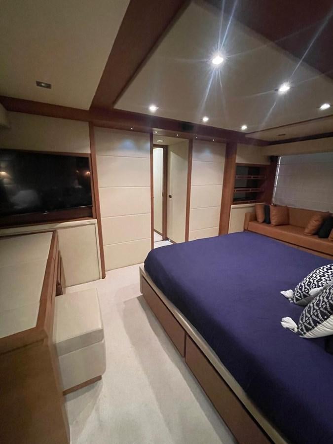 a room with a bed and a television aboard M&M Yacht for Sale