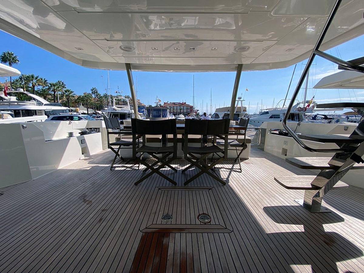 a deck with a table and chairs on it aboard MY PRINCESS OF THE SEAS Yacht for Sale