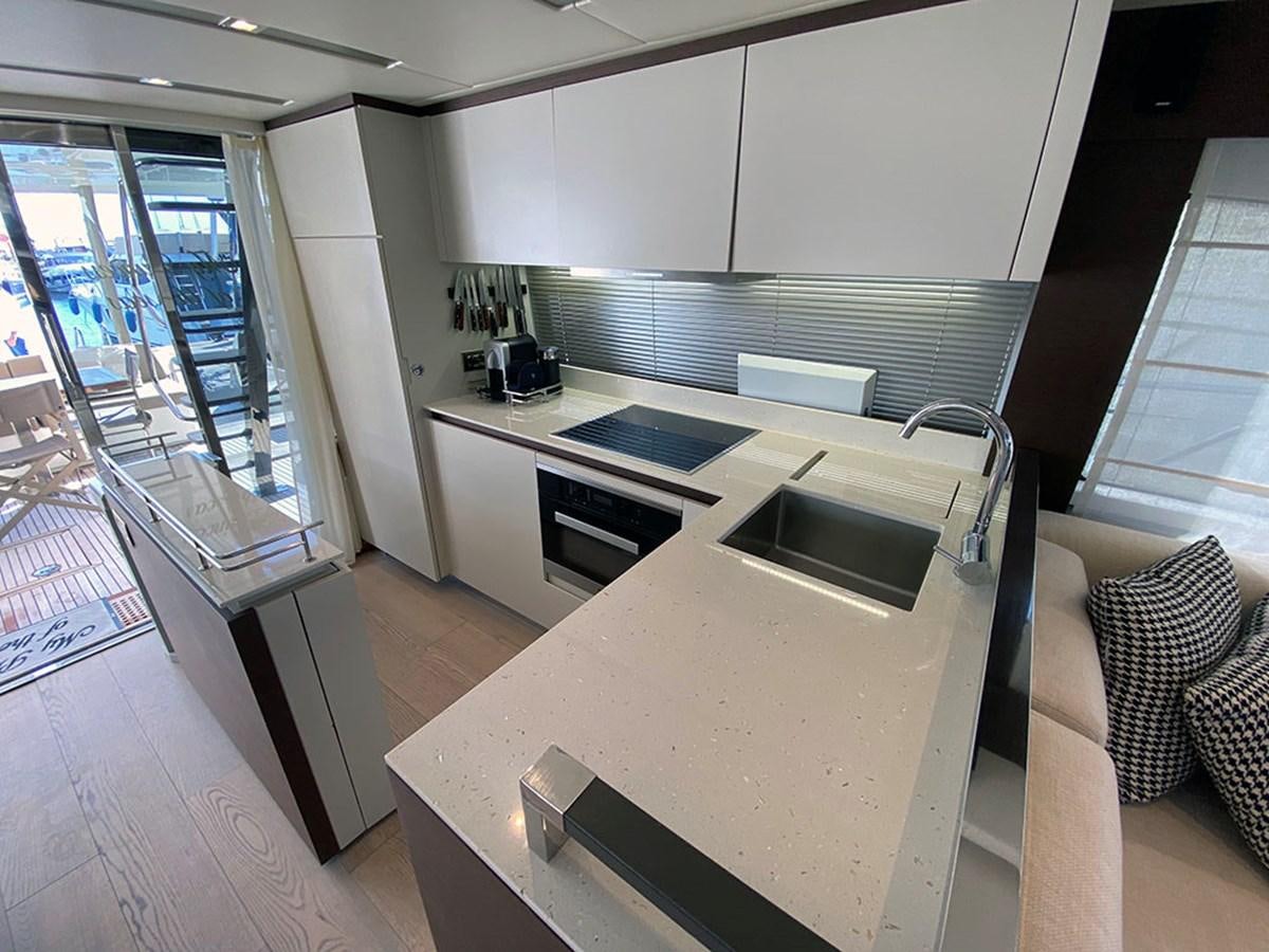 a kitchen with white cabinets aboard MY PRINCESS OF THE SEAS Yacht for Sale
