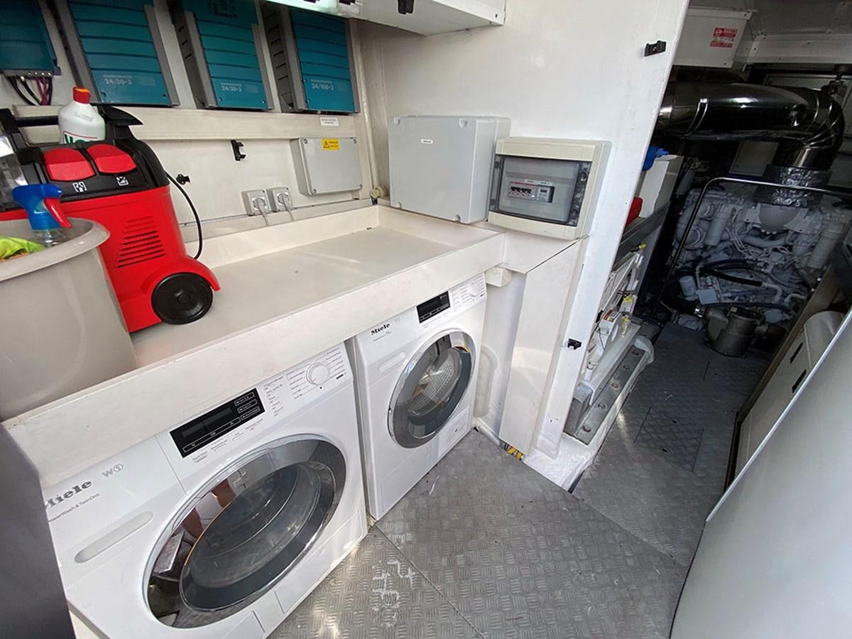 a room with a washing machine and a sink aboard MY PRINCESS OF THE SEAS Yacht for Sale